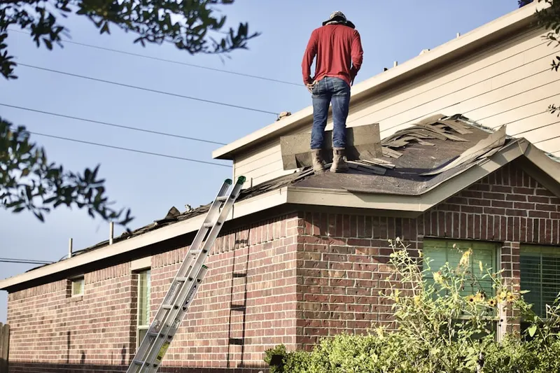 Professional roofer working on a residential roof in Windsong Farms